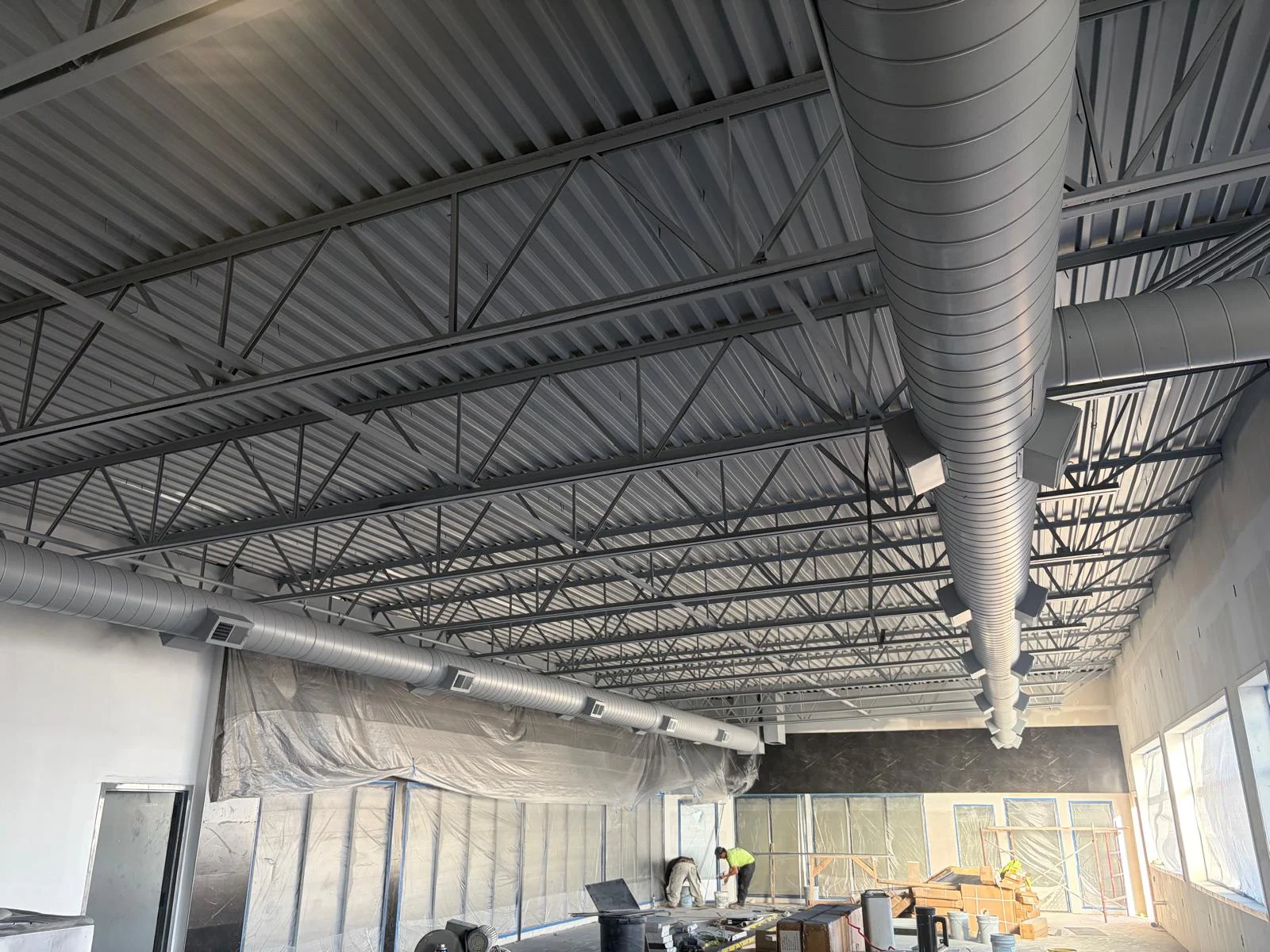 Exposed spiral supply ductwork installation view